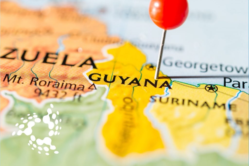 Close-up of a map with a red pin marking Guyana, symbolizing a fresh start and new opportunities in 2025.