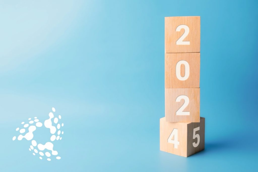Wooden blocks transitioning from 2024 to 2025 on a blue background, representing the financial year-end in Guyana.