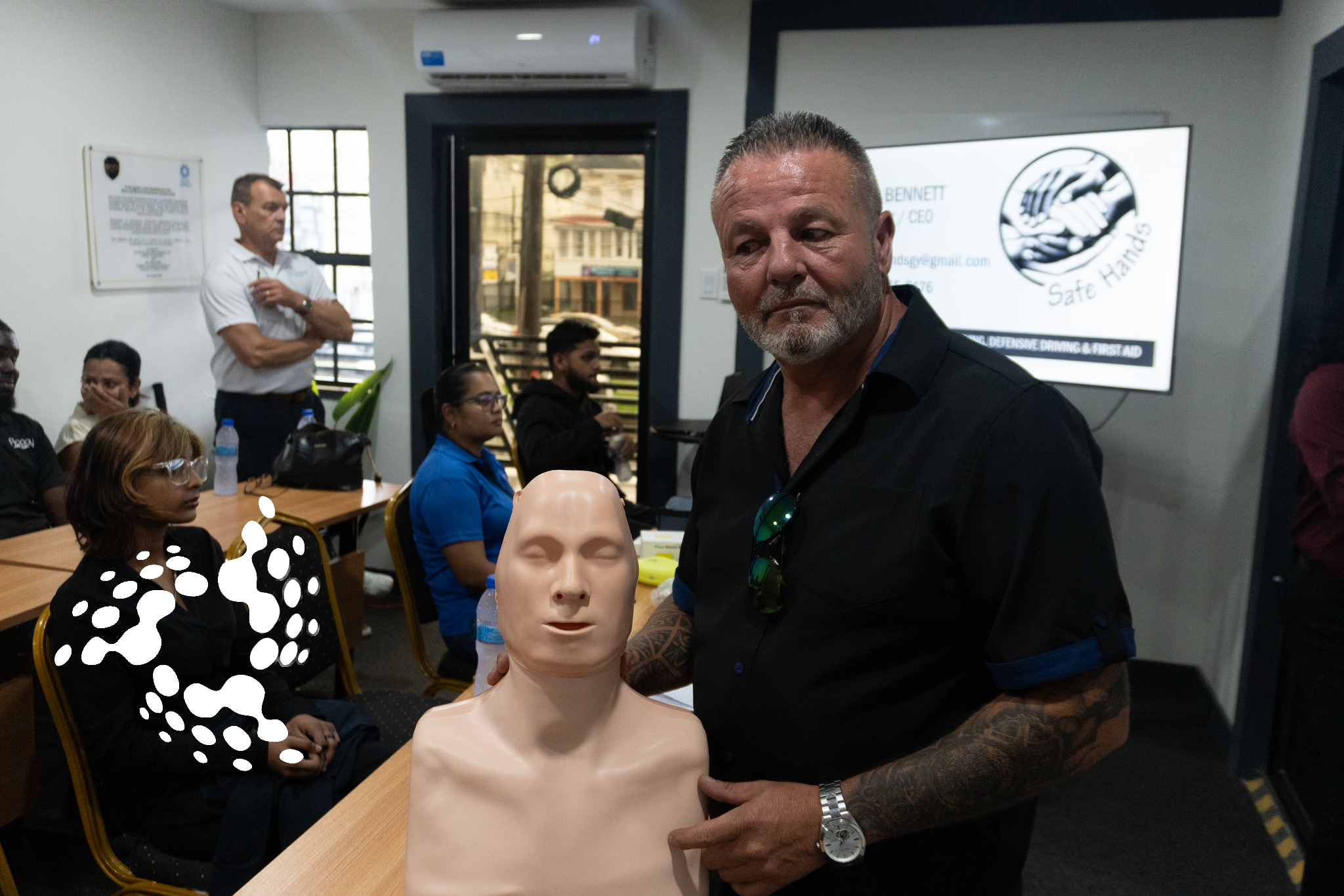 David Bennett of Safe Hands leads a first-aid demonstration during HSE training in Guyana, using a CPR manikin at the GCCI conference room in Georgetown.